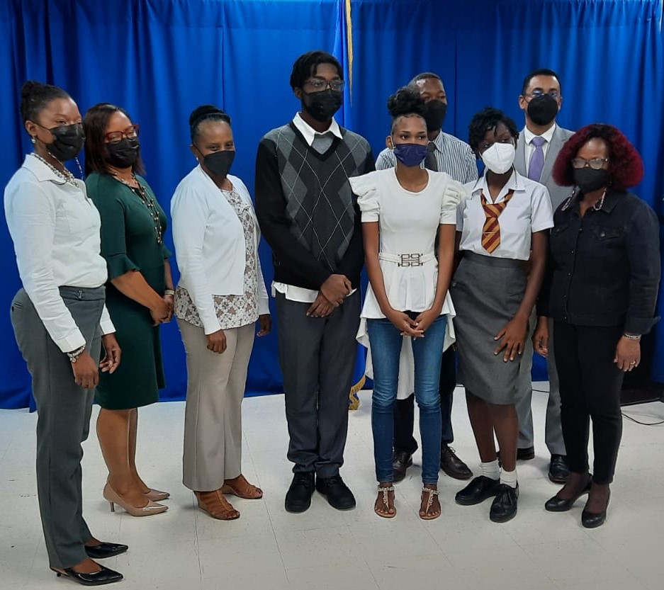 Winners & collaborators of the OAS Poetry Competition, 25 March 2022 from front left to right: Dr. Ramona Archer-Bradshaw (Ministry of Education, Technological & Vocational Training, Ms. Simone Reid (Radisson Aquatica Resort), Ms. Erika Watson (OAS), Mr. Abayomi Marshall-1st prize winner, Ms. Nicia Thompson-3rd prize winner, Ms. Abianna Fenty-2nd prize winner, Dr. Idamay Denny (MET&VT). Back right to left Mr. Shimon McIntosh (RBC Royal Bank), Mr. Henderson Wiltshire (MET&VT)